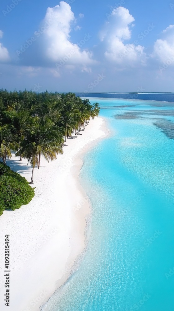 A stretch of white sand beach gently curves along the shoreline, bordered by lush palm trees and vibrant turquoise waters. The sky is clear with a few fluffy clouds.
