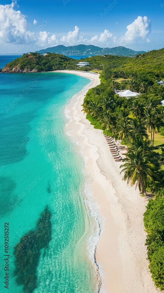 Crystal clear turquoise water gently laps against the soft sandy shore, surrounded by lush greenery and palm trees. The scene captures a peaceful tropical paradise under a bright blue sky.