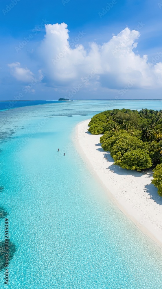 Serene turquoise waters lap against the shore of a stunning beach, where two people are enjoying the tranquil surroundings under a bright blue sky.