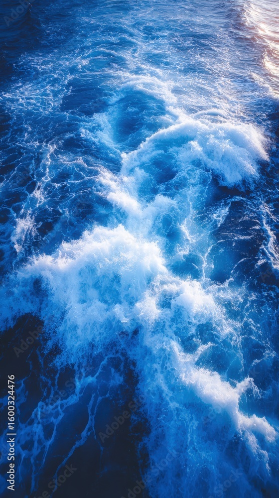 Turquoise waves ripple and crash against each other, creating white frothy crests. The scene captures the dynamic beauty of the ocean during the golden hour, with soft light reflecting on the water.